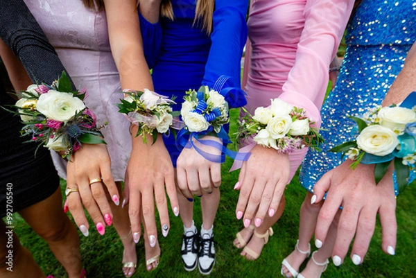 Fototapeta A group of girls and their colorful corsage Flowers for High School Prom. Colorful flower arrangements