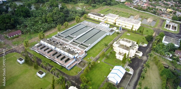 Fototapeta Aerial view of green nature with rice fields and housing.