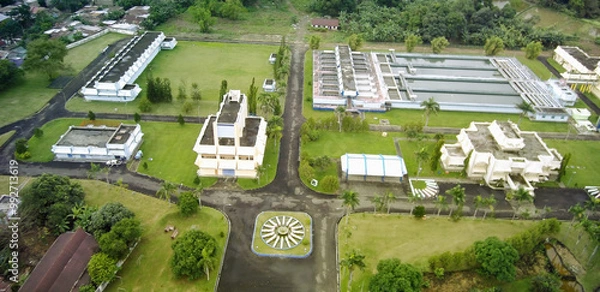 Fototapeta Aerial view of green nature with rice fields and housing.
