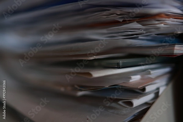 Fototapeta Stack of magazines, books, papers in the office.