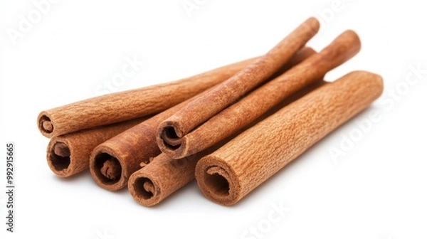 Fototapeta Close-up of several cinnamon sticks isolated on a white background, showcasing the texture and natural brown color of this popular spice.