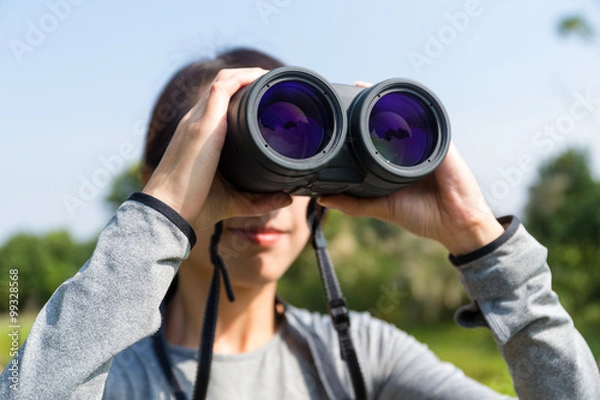 Fototapeta Woman use of the binocular in forest