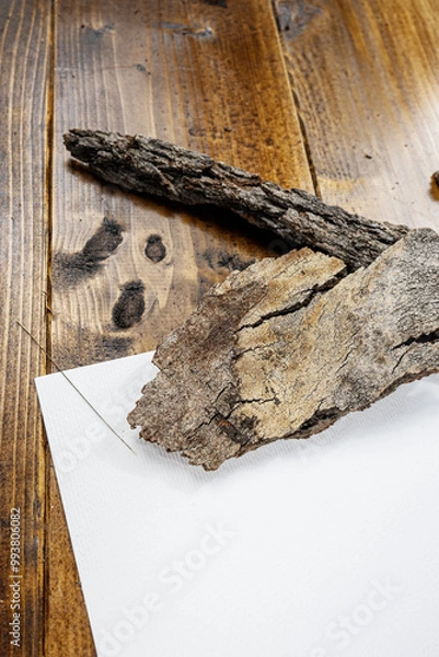 Fototapeta white sheet on wooden background with bark