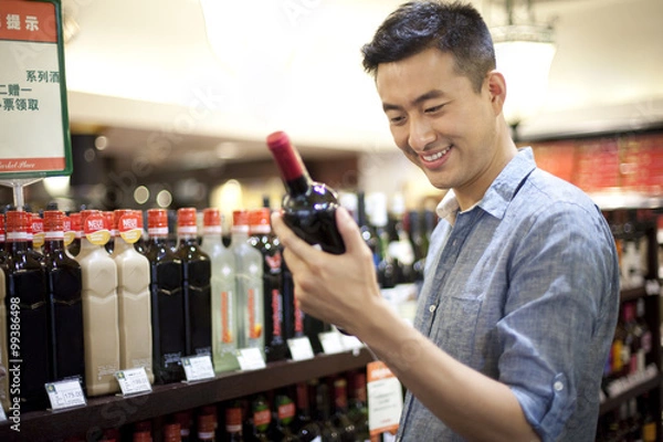 Obraz Young man shopping in supermarket