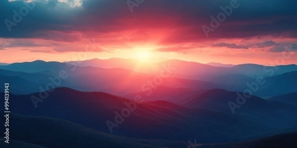 Fototapeta A mesmerizing panorama of rolling hills bathed in the warm hues of a spectacular sunset, casting long shadows across the landscape