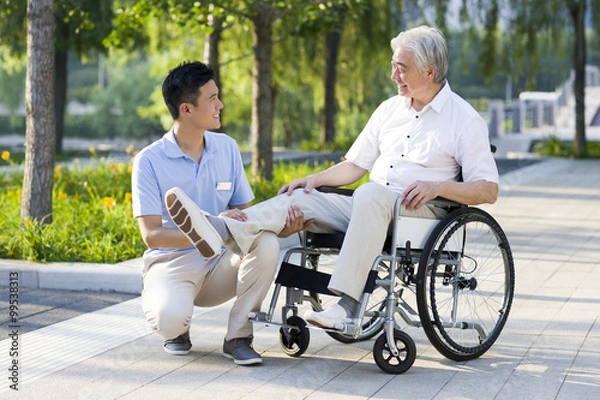 Obraz Wheelchair bound man with nursing assistant