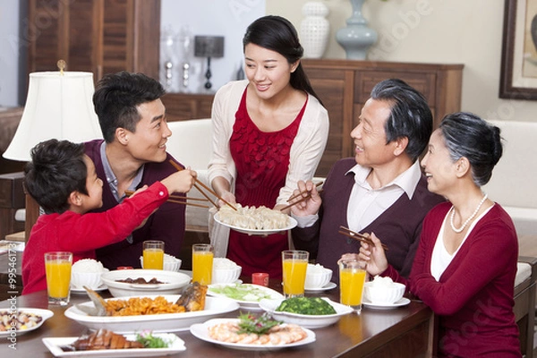 Obraz Merry family having Chinese New Year dinner