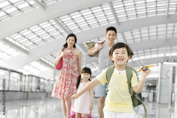 Obraz Happy family with luggage at the airport