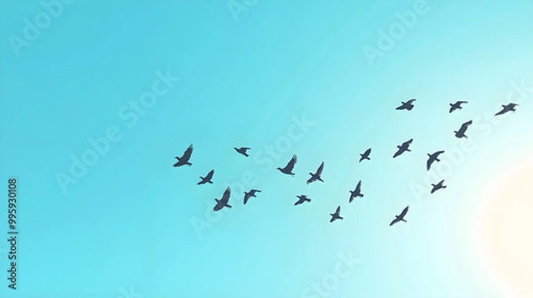Obraz Flock of birds migrating across a clear blue sky