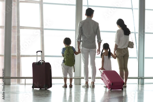 Obraz Young family looking at view at the airport