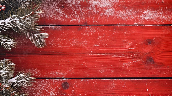 Fototapeta Snowy spruce branches on a vivid red wood background