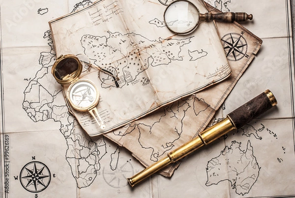 Fototapeta An old brass compass on map background