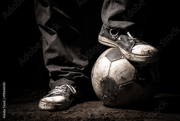Fototapeta Ragged sneakers with a soccer ball