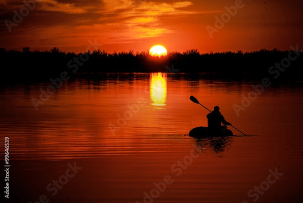 Fototapeta man in kayaking on Lake at sunset