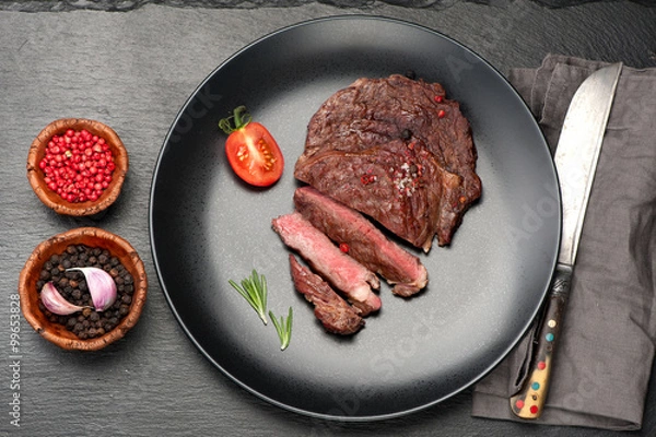 Obraz medium Beef Steak Ribeye on black stone background
