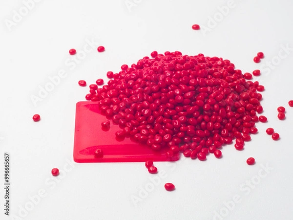 Fototapeta Red masterbatch granules isolated on white background, color pigment carrier polymer in plastics industry