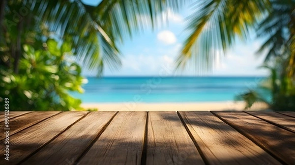 Fototapeta Empty wooden table top with blurred tropical beach background for product display montage, with copy space