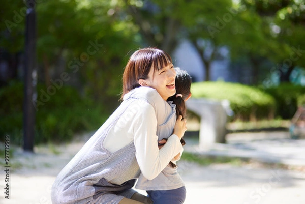 Fototapeta 子供と抱き合う笑顔の保育士の女性