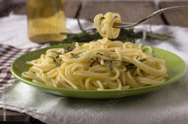 Fototapeta Green plate with spaghetti and hanging fork