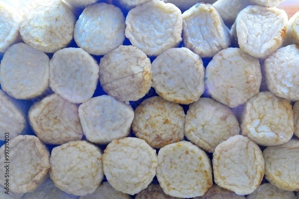 Fototapeta Fish balls in the form of round sticks, stacked on top of each other.
