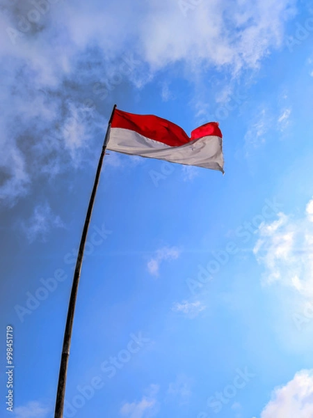Fototapeta Indonesian flag with cloudy sky background