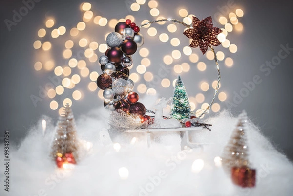 Fototapeta Christmas deoration concept on holidays with a porcelain derr, white fake snow for a festive december. In the background are bokeh balls made of lights