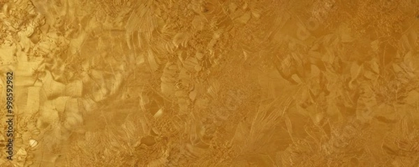 Fototapeta a close-up view textured gold surface, with a pattern of small, irregularly shaped leaves and branches