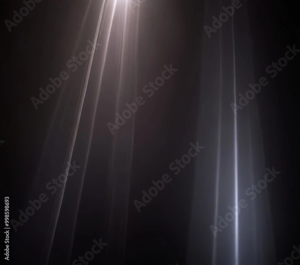 Fototapeta a dramatic lighting effect with bright, white light rays extending diagonally across the frame, creating a sense of depth and movement
