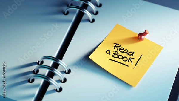 Fototapeta Closeup Yellow Sticky Note paste it in a notebook setting an app