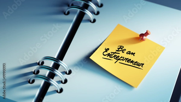 Fototapeta Closeup Yellow Sticky Note paste it in a notebook setting an app