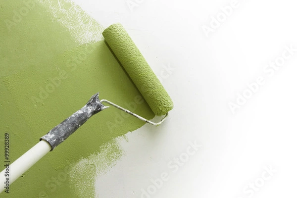 Obraz Paint roller applying paint on white wall, home improvements