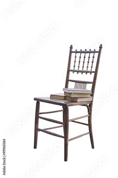 Fototapeta isolated chair with books stacked on them from a library or school