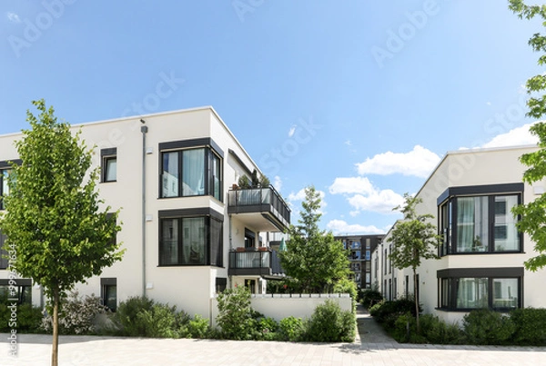 Obraz Residential area with ecological and sustainable green residential buildings, low-energy houses with apartments and green courtyard