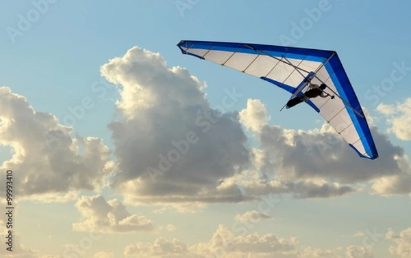 Obraz Hang Glider flying in the sky on blue day