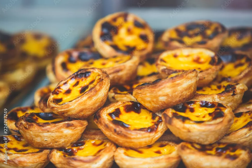 Fototapeta Tradycyjne portugalskie jajka tartowe ciasta, deser pasteis de nata z różnym portugalskim ciasta w oknie kawiarni, pastel de nata