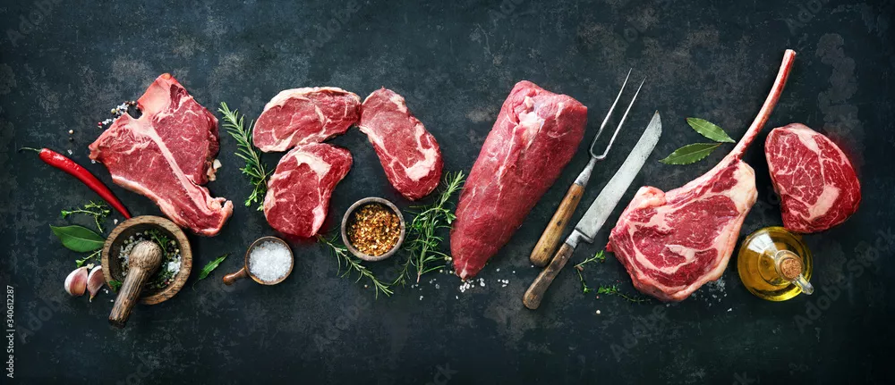 Obraz Różnorodne steki z surowego mięsa wołowego do grillowania z przyprawami i naczyniami